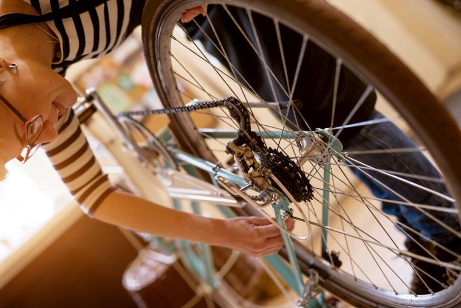 Woman maintaining her bike